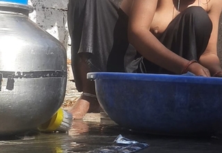 Indian stepsister is soon to border on take a bath while washing attire in the open range of the house