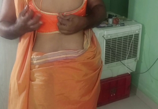 married glamour women orange saree standing position romance
