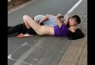 A lifelike Chinese couple, reunited after a long absence, surrenders to steamy public desire superior to before the bustling street.