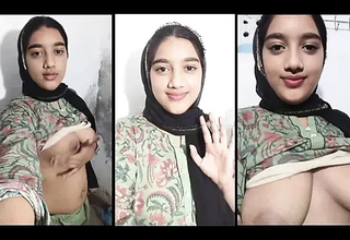 Stunning hijabi beauty teasing her monumental breasts nearly close while whispering dirty.