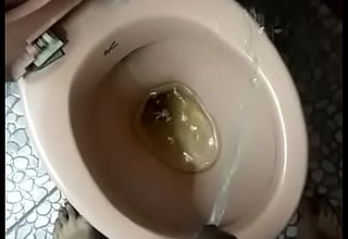 Indian boy pissing close to toilet