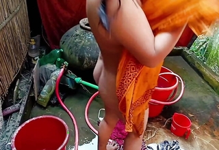Elegant Desi village girl bathing in an obstacle open.